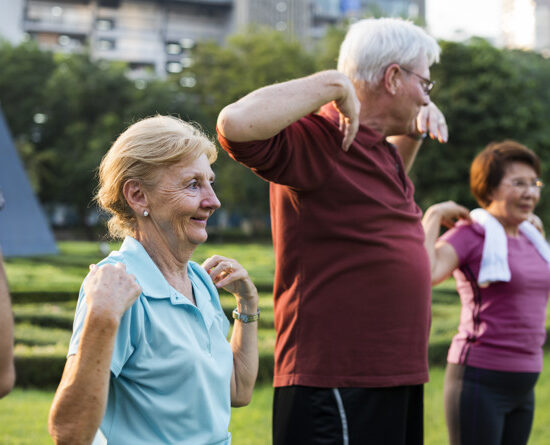 Group of senior friends stretching together in a park